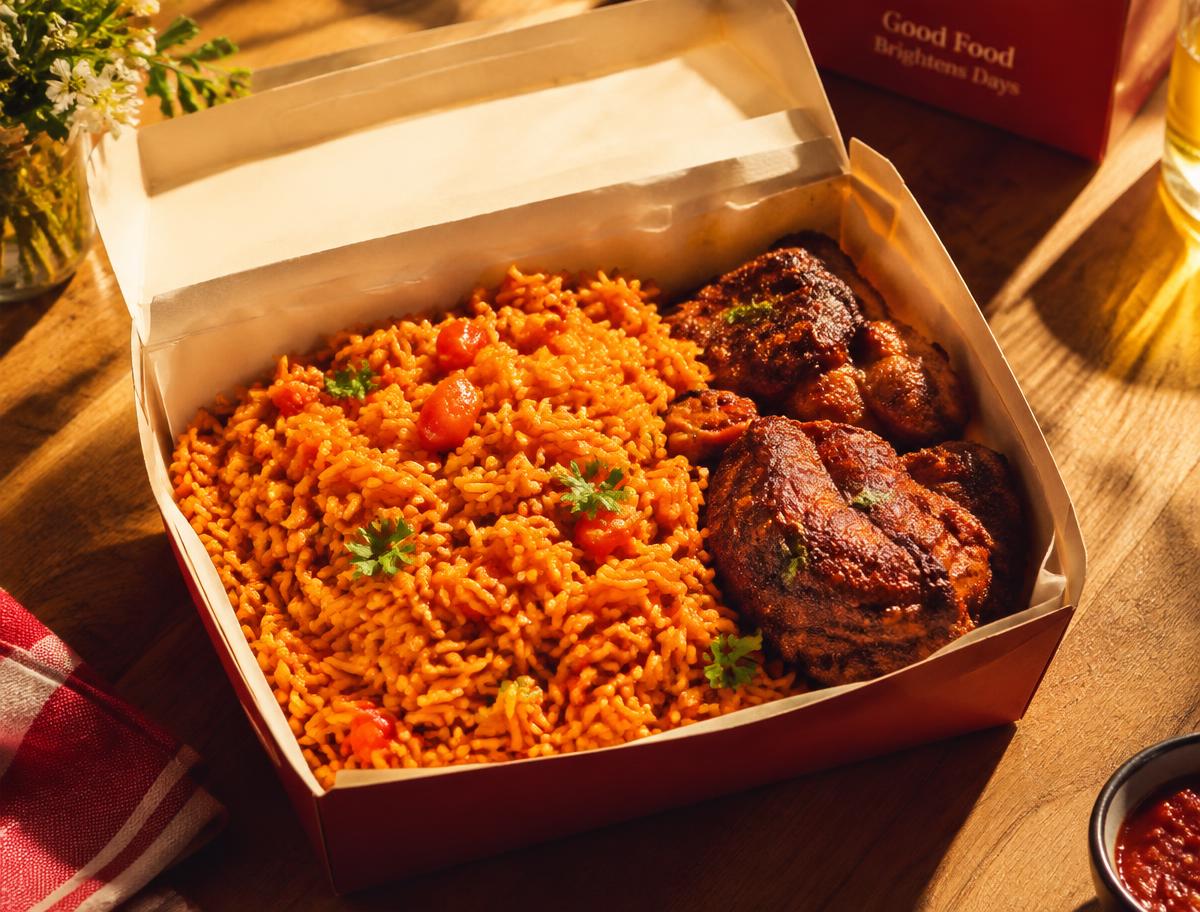 Boxed jollof rice with spiced chicken